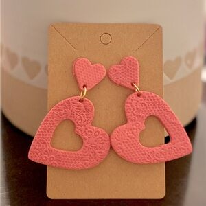 Pink textured heart clay earrings.